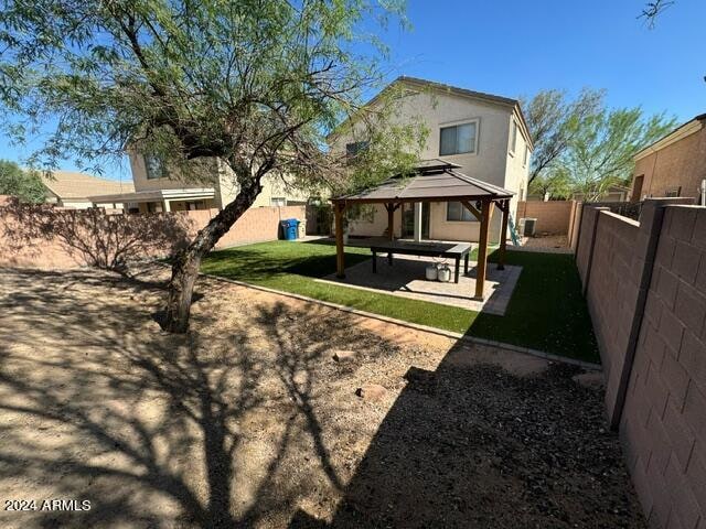 back of house featuring a patio, a gazebo, and a yard