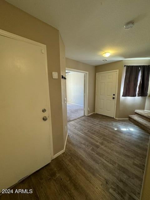 corridor featuring dark hardwood / wood-style flooring