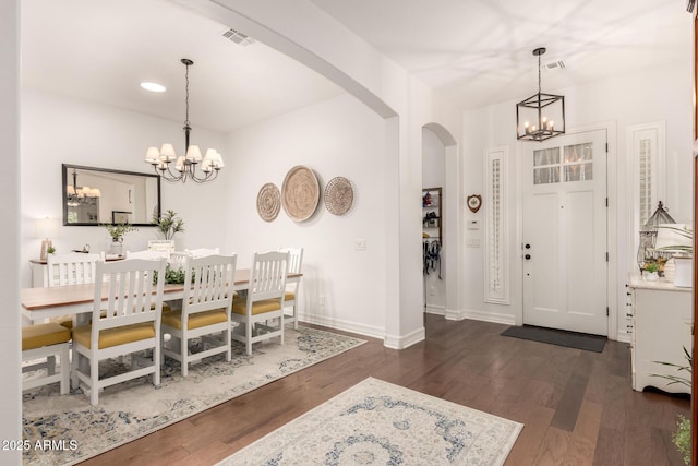 2879 E Austin Dr, Gilbert, AZ 85296 - dining space featuring a chandelier, arched walkways, dark wood finished floors, recessed lighting, and baseboards