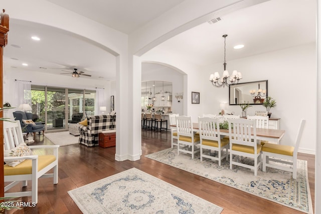 2879 E Austin Dr, Gilbert, AZ 85296 - dining area featuring a ceiling fan, arched walkways, recessed lighting, dark wood-style flooring, and a chandelier