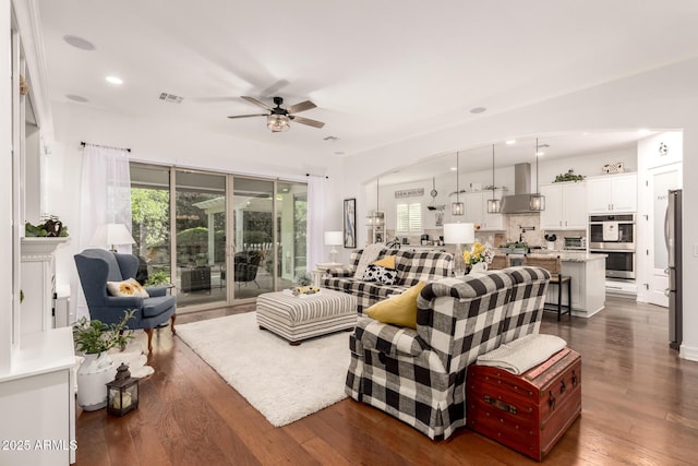 2879 E Austin Dr, Gilbert, AZ 85296 - living room featuring ceiling fan, dark wood-style flooring, recessed lighting, and arched walkways