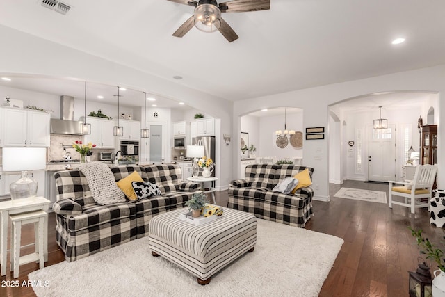 2879 E Austin Dr, Gilbert, AZ 85296 - living area with arched walkways, a ceiling fan, dark wood-type flooring, a chandelier, and recessed lighting