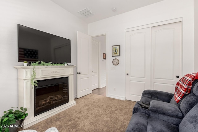 2879 E Austin Dr, Gilbert, AZ 85296 - living area with a glass covered fireplace, carpet floors, and baseboards