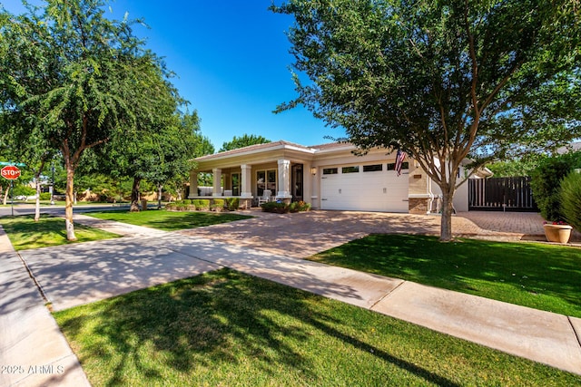2879 E Austin Dr, Gilbert, AZ 85296 - view of front of home featuring an attached garage, driveway, covered porch, stucco siding, and stone siding