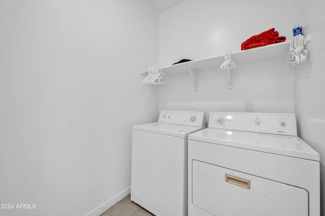 clothes washing area featuring washer and clothes dryer