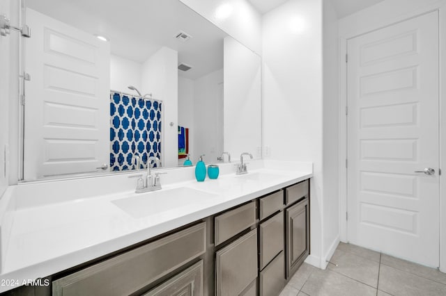 bathroom with a shower with shower curtain, vanity, and tile patterned floors