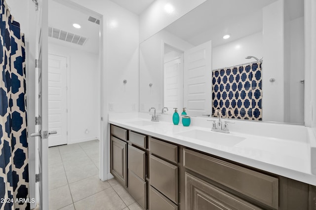 bathroom with tile patterned flooring and vanity