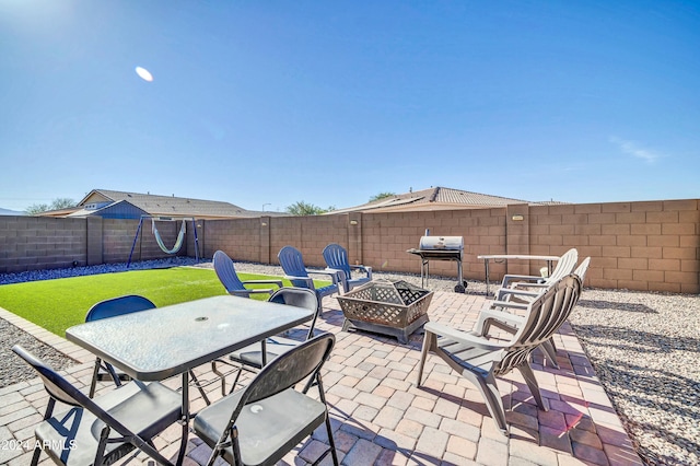 view of patio / terrace with an outdoor fire pit and a grill