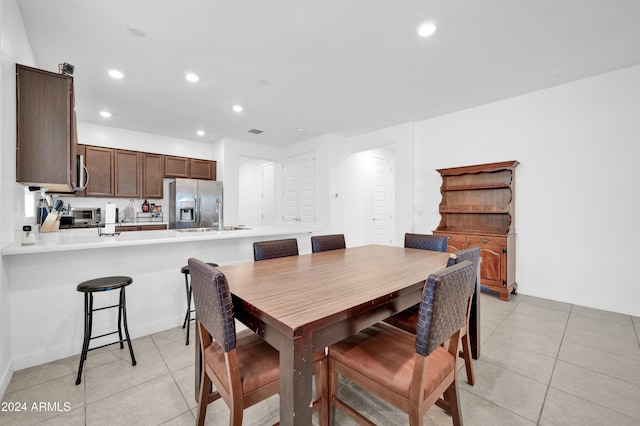 dining area with light tile patterned floors