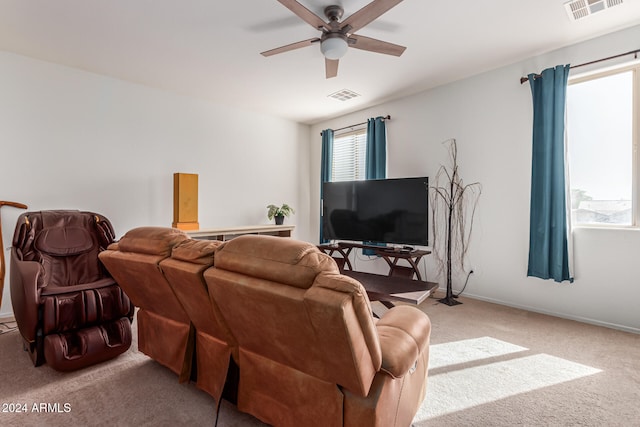 carpeted living room featuring ceiling fan