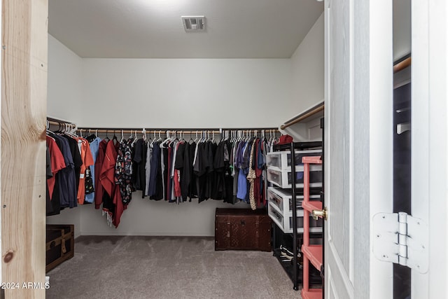 walk in closet featuring carpet