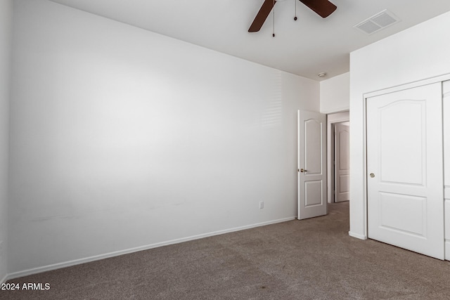 unfurnished bedroom featuring carpet floors, a closet, and ceiling fan