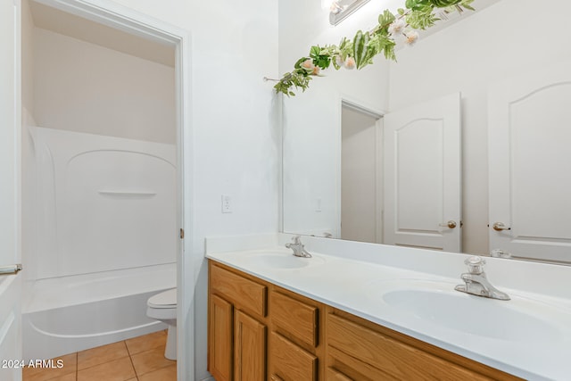 full bathroom featuring vanity, washtub / shower combination, toilet, and tile patterned flooring