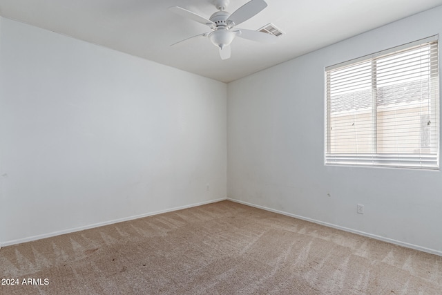 spare room with light colored carpet and ceiling fan