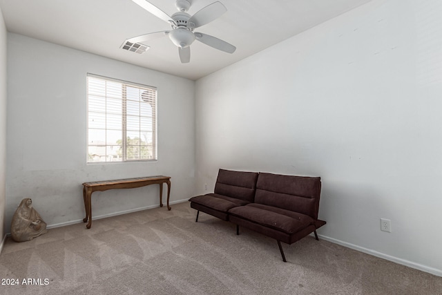 sitting room featuring light carpet and ceiling fan