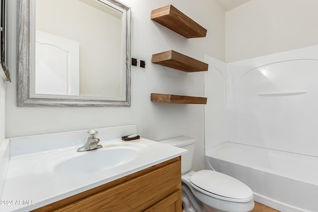 full bathroom featuring toilet, vanity, and tub / shower combination