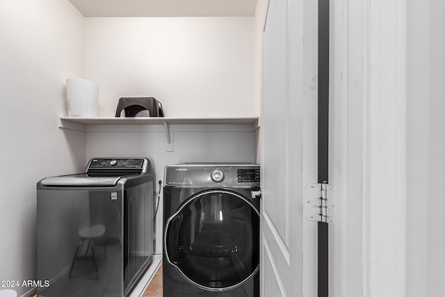 laundry room featuring tile patterned floors and separate washer and dryer