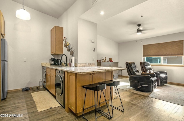 1185 W University Ave Unit 228, Flagstaff, AZ 86001 - kitchen featuring washer / clothes dryer, a ceiling fan, wood finished floors, and light stone counters