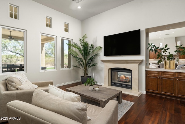 8240 E Wingspan Way, Scottsdale, AZ 85255 - living area with dark wood-style floors, a premium fireplace, recessed lighting, a ceiling fan, and baseboards