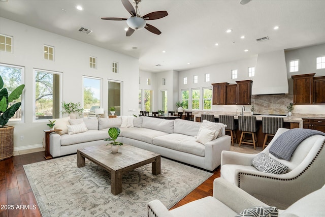 8240 E Wingspan Way, Scottsdale, AZ 85255 - living room with recessed lighting, a high ceiling, a ceiling fan, dark wood finished floors, and baseboards
