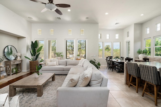 8240 E Wingspan Way, Scottsdale, AZ 85255 - living room with a towering ceiling, recessed lighting, a ceiling fan, light tile patterned floors, and baseboards