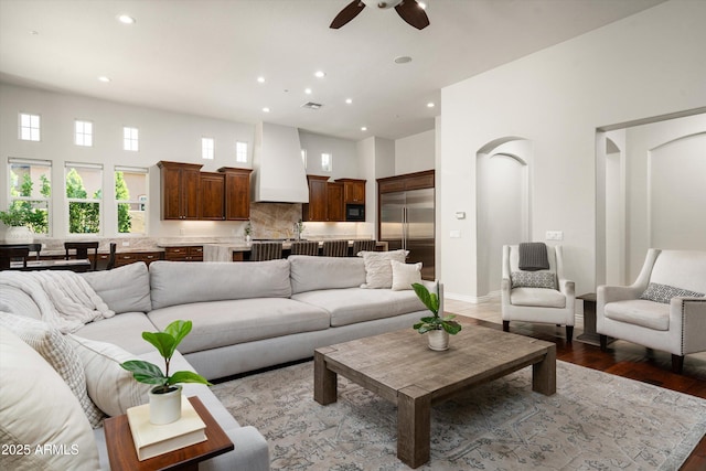 8240 E Wingspan Way, Scottsdale, AZ 85255 - living area featuring ceiling fan, recessed lighting, a towering ceiling, light wood finished floors, and baseboards