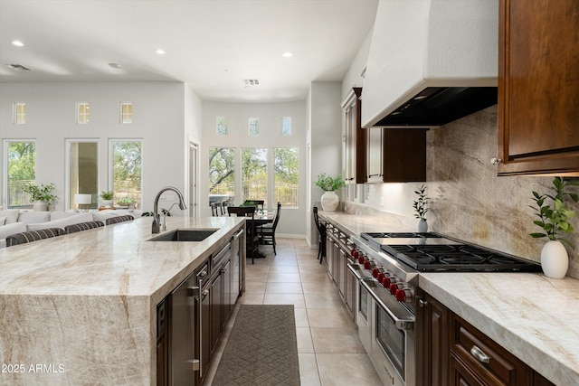 8240 E Wingspan Way, Scottsdale, AZ 85255 - kitchen with a sink, premium range hood, recessed lighting, light tile patterned floors, and backsplash