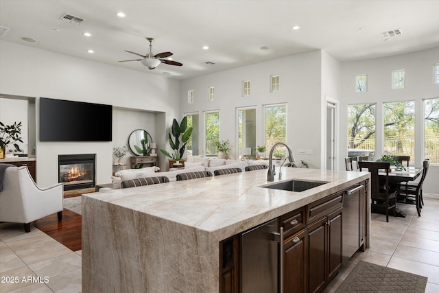 8240 E Wingspan Way, Scottsdale, AZ 85255 - kitchen featuring a sink, recessed lighting, a glass covered fireplace, a high ceiling, and a ceiling fan