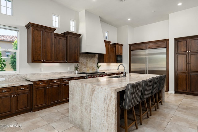 8240 E Wingspan Way, Scottsdale, AZ 85255 - kitchen featuring a sink, stainless steel appliances, light tile patterned flooring, a center island with sink, and plenty of natural light