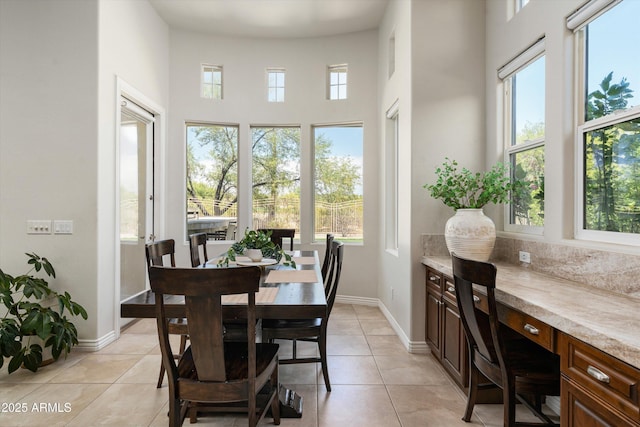 8240 E Wingspan Way, Scottsdale, AZ 85255 - dining area with light tile patterned flooring, a high ceiling, baseboards, and an office area