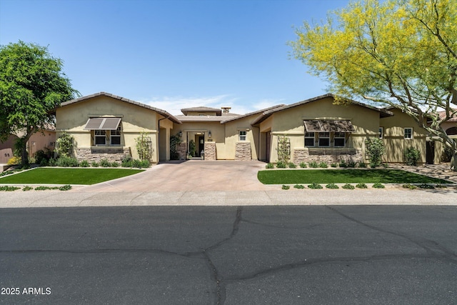 8240 E Wingspan Way, Scottsdale, AZ 85255 - view of front of house featuring stone siding, driveway, an attached garage, stucco siding, and a front yard