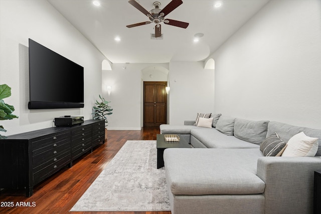 8240 E Wingspan Way, Scottsdale, AZ 85255 - living room with arched walkways, a ceiling fan, dark wood-type flooring, recessed lighting, and baseboards