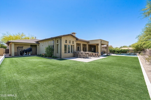 8240 E Wingspan Way, Scottsdale, AZ 85255 - rear view of property featuring a patio, stucco siding, and a yard