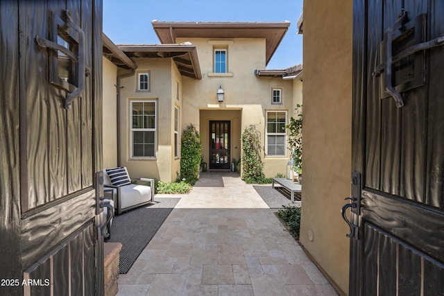 8240 E Wingspan Way, Scottsdale, AZ 85255 - doorway to property with stucco siding and a patio area
