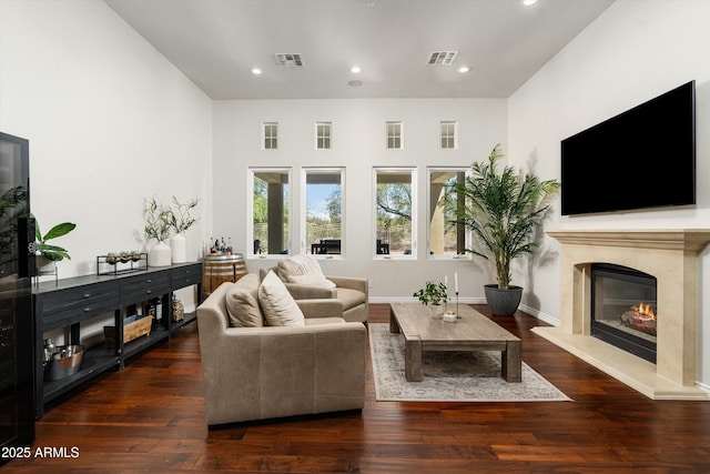 8240 E Wingspan Way, Scottsdale, AZ 85255 - living room featuring a high end fireplace, recessed lighting, wood finished floors, and baseboards