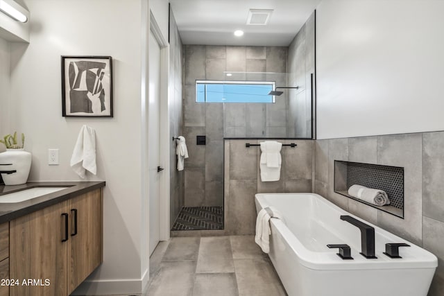 bathroom featuring vanity, separate shower and tub, and tile walls