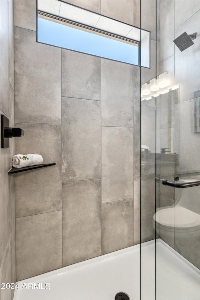 bathroom with tiled shower