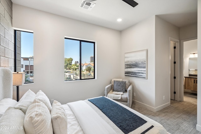 bedroom with light carpet and connected bathroom