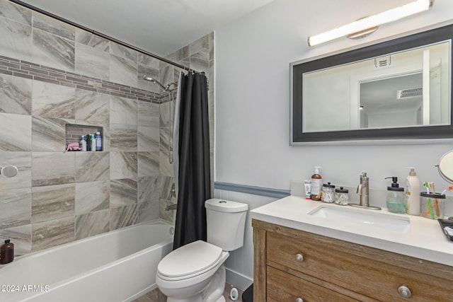 full bathroom featuring vanity, shower / tub combo, and toilet