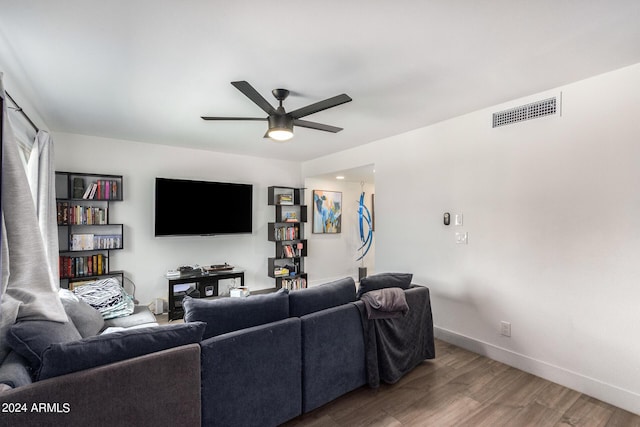 living room featuring hardwood / wood-style flooring and ceiling fan