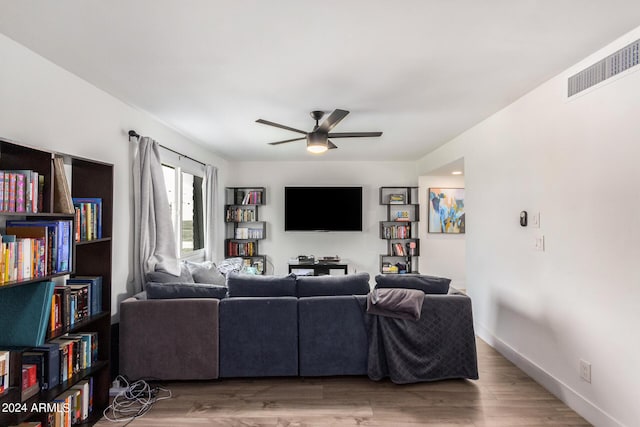 living room with wood-type flooring and ceiling fan