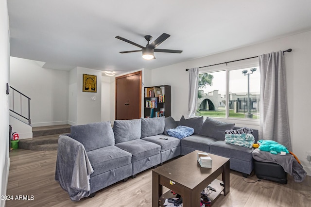 living room featuring ceiling fan and light wood-type flooring