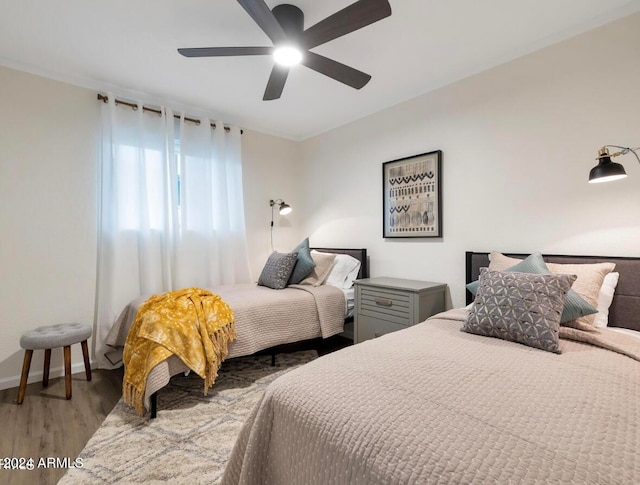 bedroom featuring ceiling fan and wood-type flooring