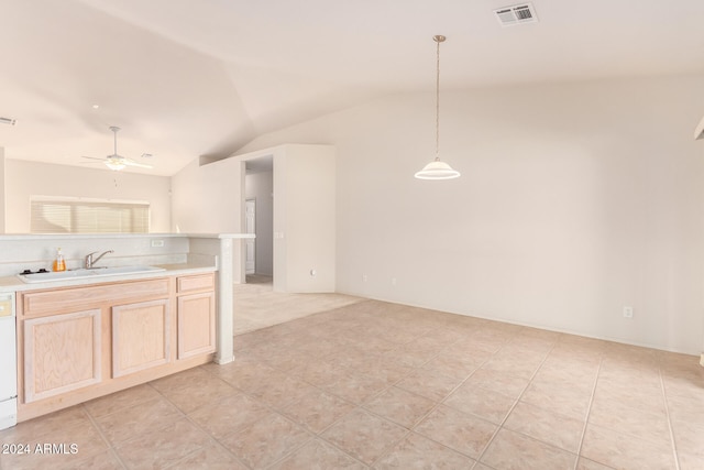 kitchen featuring light brown cabinets, hanging light fixtures, sink, lofted ceiling, and ceiling fan