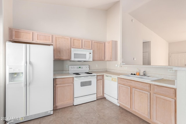 kitchen with light tile patterned flooring, light brown cabinetry, sink, white appliances, and lofted ceiling