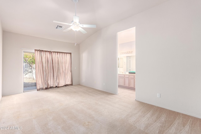 spare room with light colored carpet, ceiling fan, and vaulted ceiling