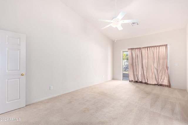 carpeted spare room featuring ceiling fan and high vaulted ceiling