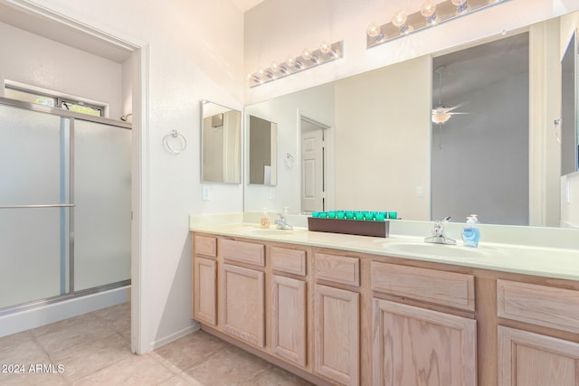 bathroom featuring walk in shower, vanity, tile patterned floors, and ceiling fan