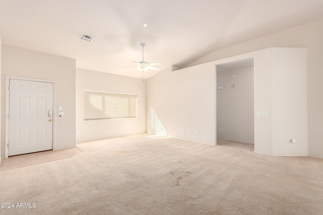 empty room featuring ceiling fan, light colored carpet, and vaulted ceiling