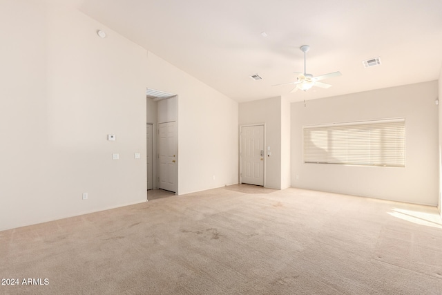 carpeted empty room with ceiling fan and vaulted ceiling